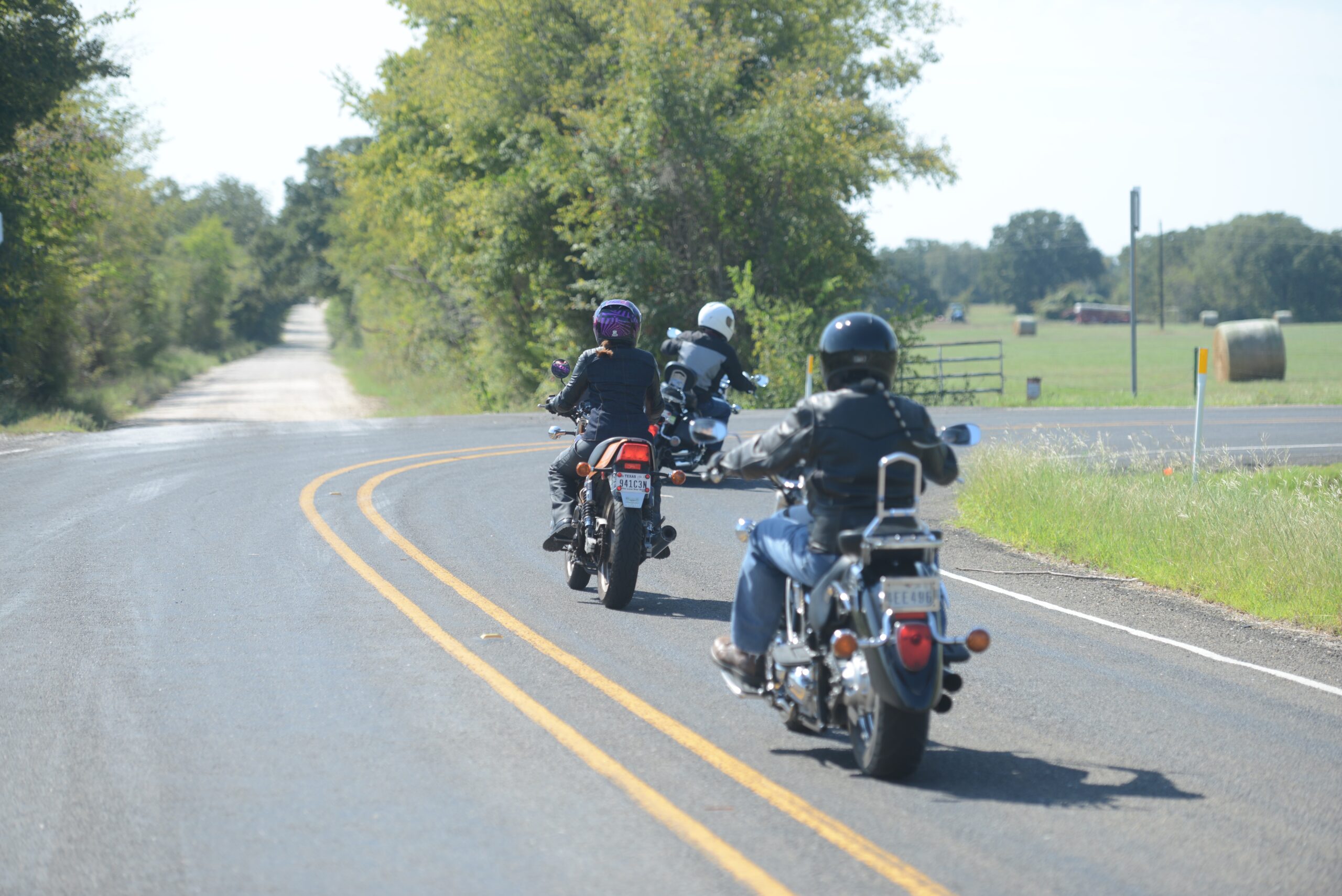 Three motorcyclists riding on rural roadway
